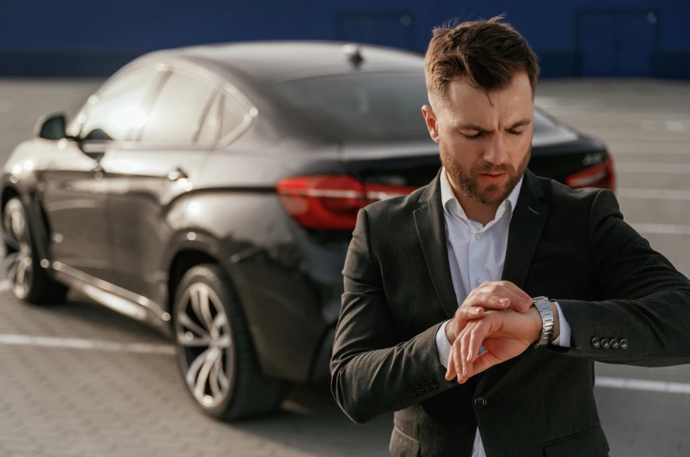 Black luxury car waiting for pickup in Boston for hourly car service